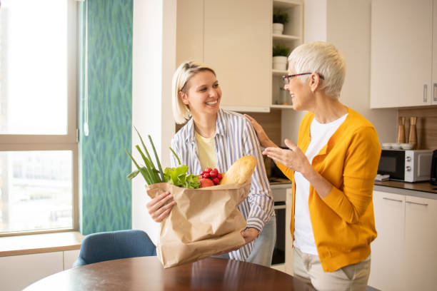 istock Volunteer is helping an elderly woman 1721353600