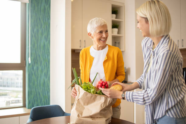 istock Volunteer is helping an elderly woman 1721353627
