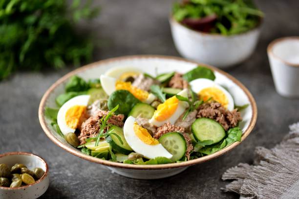 Healthy canned tuna salad with capers, egg, potato and cucumber. stock photo