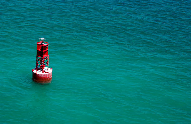 Channel Marker A red channel marker in the beautiful blue green waters of the Caribbean. channel marker stock pictures, royalty-free photos & images