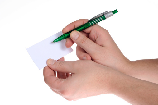 Hand holding a blank white card on a white background