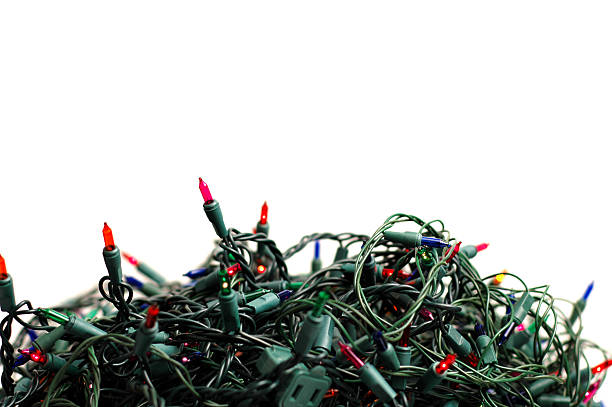 Pile of Tangled Christmas Lights on White Background stock photo