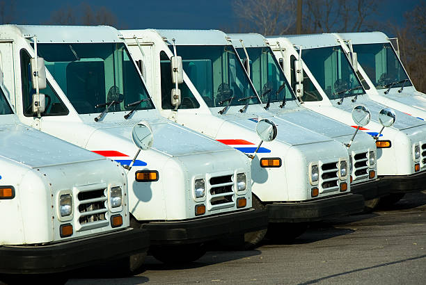 Here Comes the Mailman! Line of postal delivery trucks ready to go.Another similar image... united states postal service photos stock pictures, royalty-free photos & images