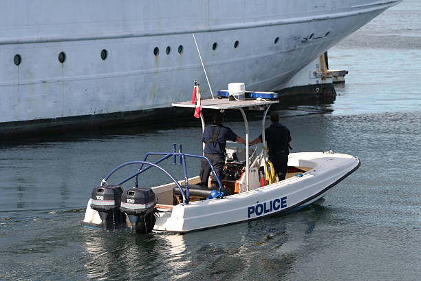 Police boat with two officers patrolling the harbour stock photo
