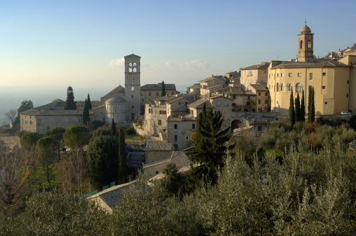 Tuscany (Italy) Looking down on a small Italian town - caught in late afternoon sunlight with a clear blue sky and distant pink cloudsTo see more use keyword tag or click on the phrase below: