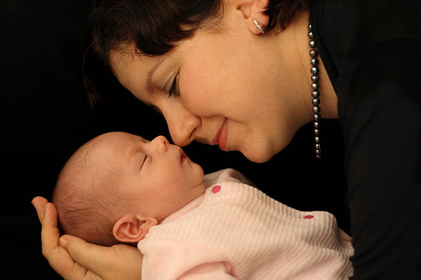 istock Newborn baby sleeping in mother's hands 172142494
