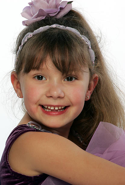 Young ballerina sitting with a great smile on her face