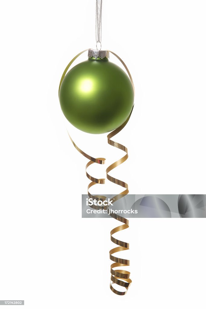Green Silver and Gold Photo of a green Christmas ball draped with a strand of gold ribbon. Bright Stock Photo