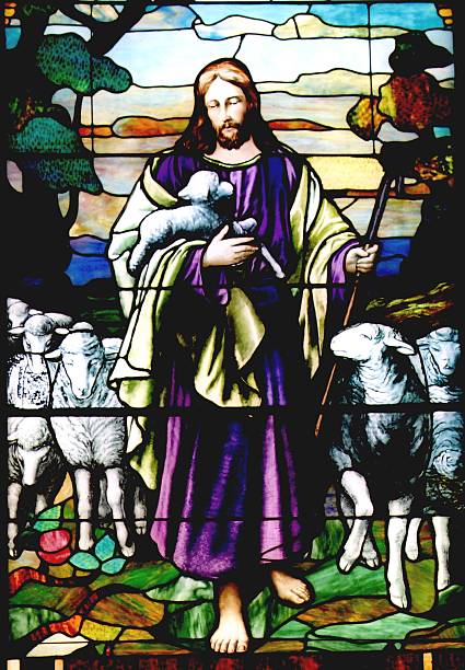 Circular stained glass window in Matthias Church in Budapest, Hungary depicting a lamb as a symbol of peace in multi colored surroundings.  