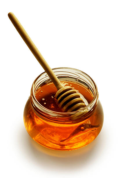 istock Glass honey pot with stick isolated on white background 172143810