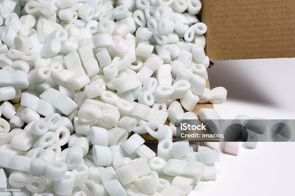 Shipping box and Styrofoam peanuts Shipping box and Styrofoam peanuts on white background. Closeup. Cut Out Stock Photo