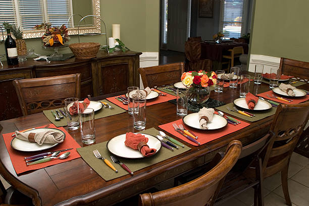 Setup of a table for dinner or lunch with modern and tasteful plates and decorative elements.