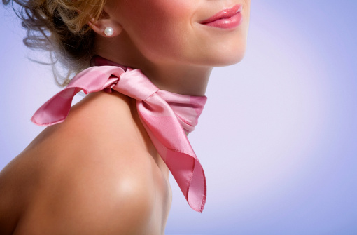 Woman wearing pink scarf.