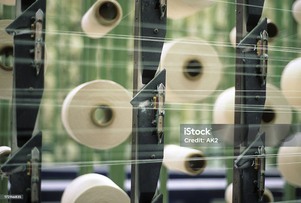 Textile industry "View of a part of a machine in a textile industry. It shows rolls of raw material being processed. Focus is on the front part of the picture, emphasing the fibers.Scanned Velvia 50." Agricultural Machinery Stock Photo