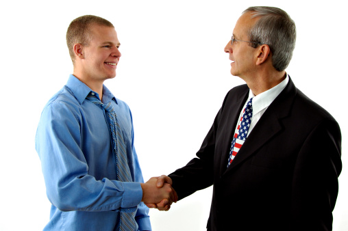 Two politicians shaking hands in agreement.  Isolated on white.  Men are models and not real politicians.