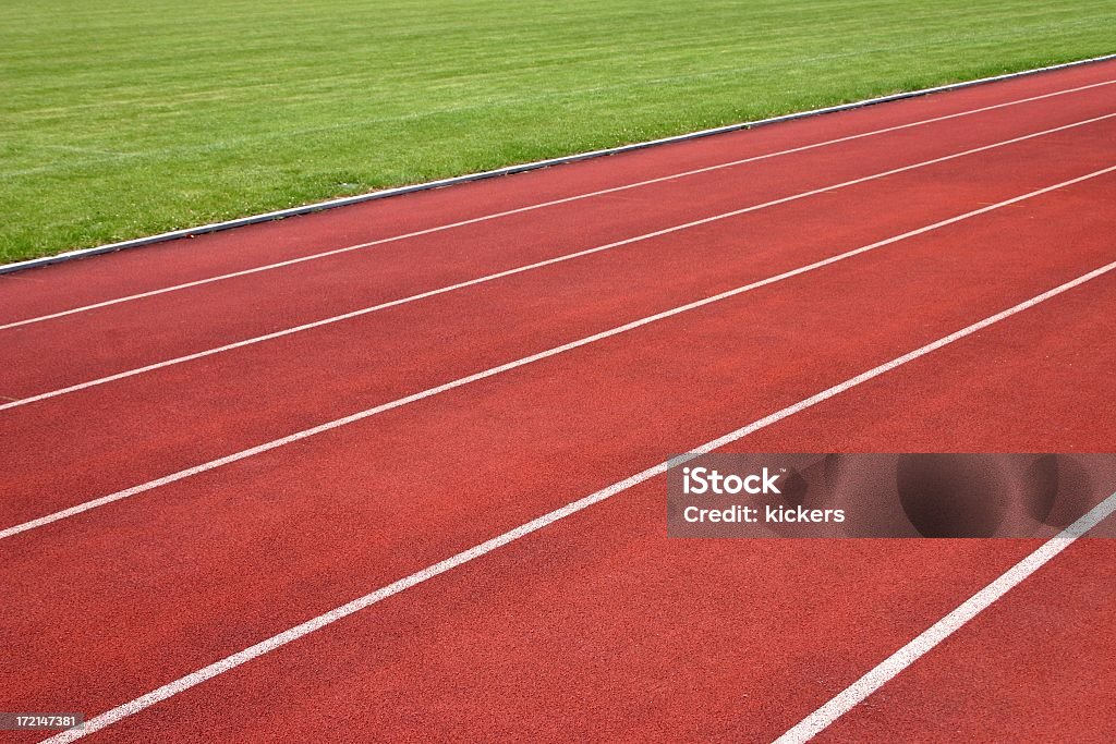 On your marks... ...set...go! A running track and a piece of soccer green. Color Image Stock Photo