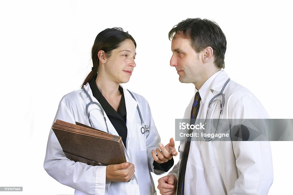 Doctors talking Doctors talking isolated on a white background. Adult Stock Photo