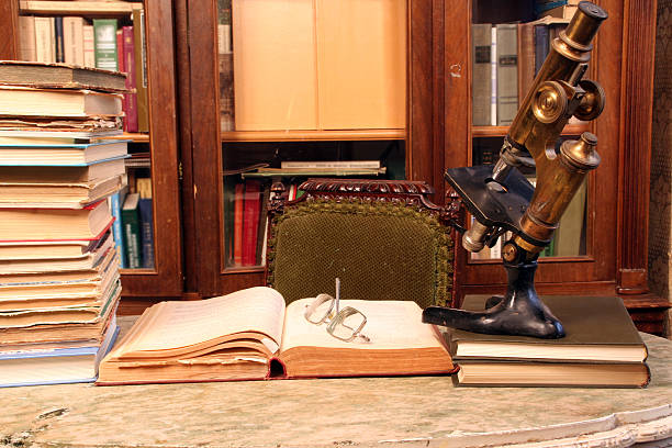 A selection of books in a library next to a telescope