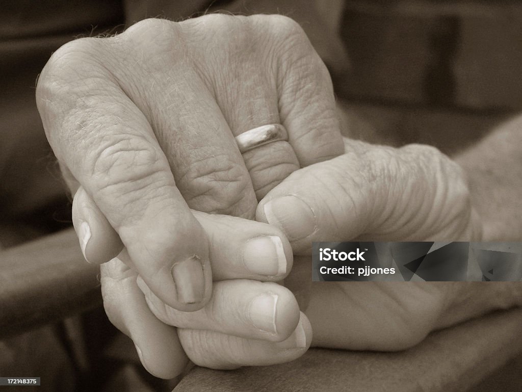 Old Hands An elderly couple hold hands. Anxiety Stock Photo