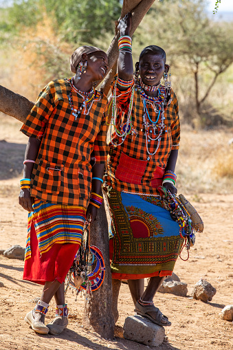 African warriors from Samburu tribe resting on savanna, central Kenya. Samburu tribe is one of the biggest tribes of north-central Kenya, and they are related to the Maasai.