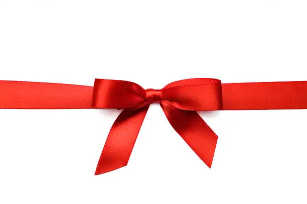 A red satin ribbon tied in a bow over a pure white background.  Clipping Path Included.