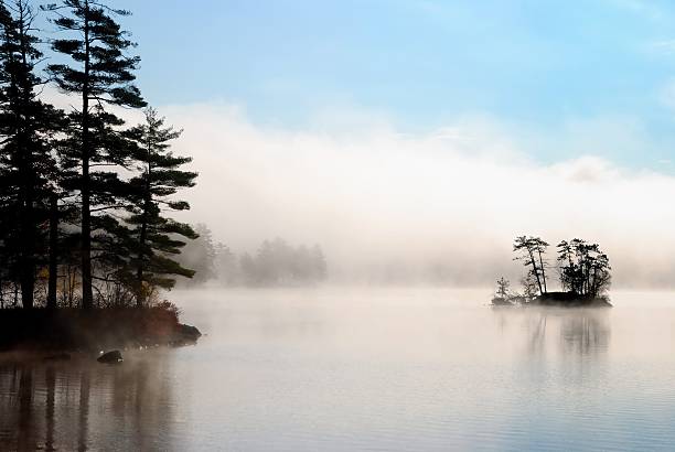 fog lifts exposing island and blue sky