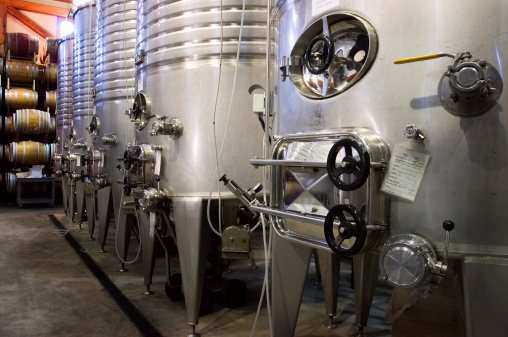 A row of fermenters inside a modern winery