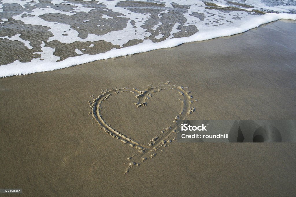 Heart in the Sand A heart carved into the sand at the beach. Animal Heart Stock Photo
