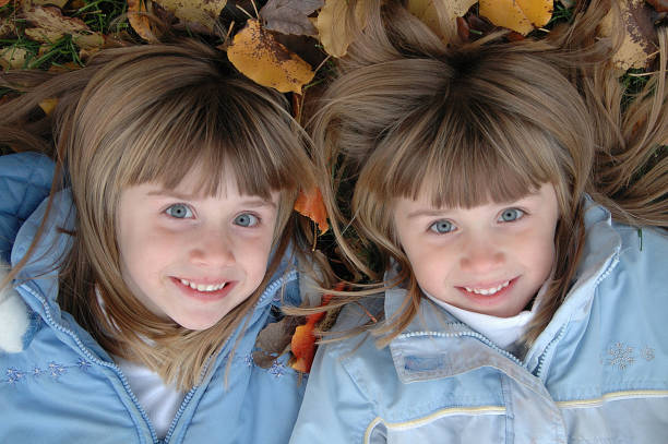 Twin Girls posing in the leaves