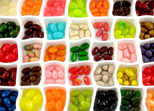 jelly bean sampler lots of jelly beans divided by color and flavor. jellybean stock pictures, royalty-free photos & images
