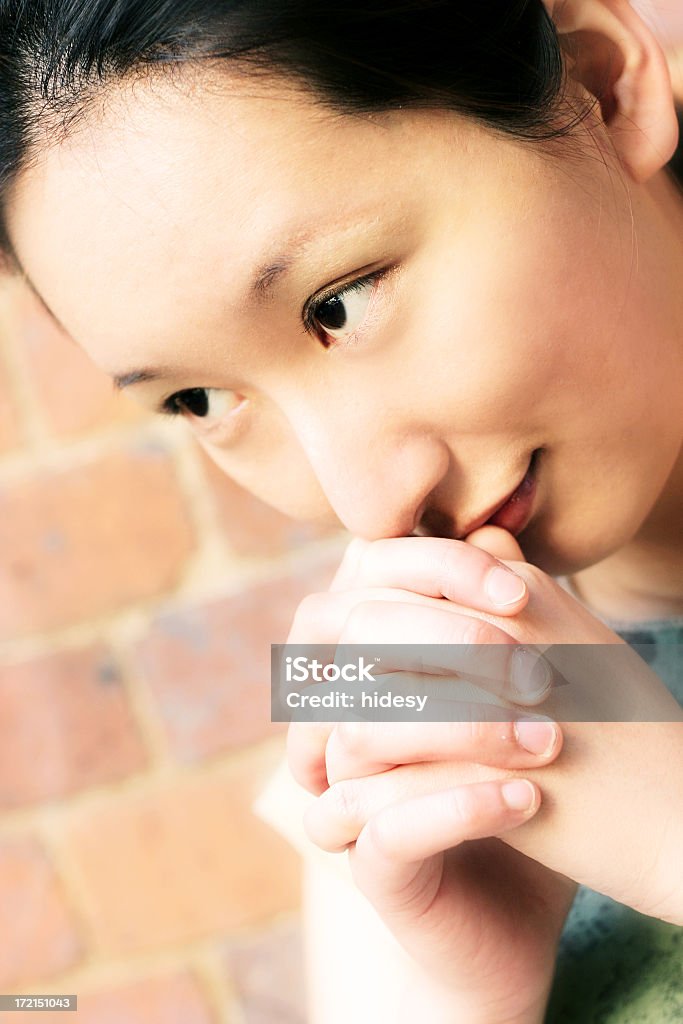 Prayer Young asian woman praying.  Shallow depth 20-24 Years Stock Photo