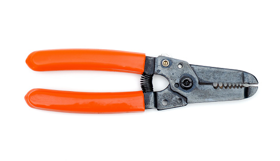 Wire stripping pliers with orange handles isolated on white background.