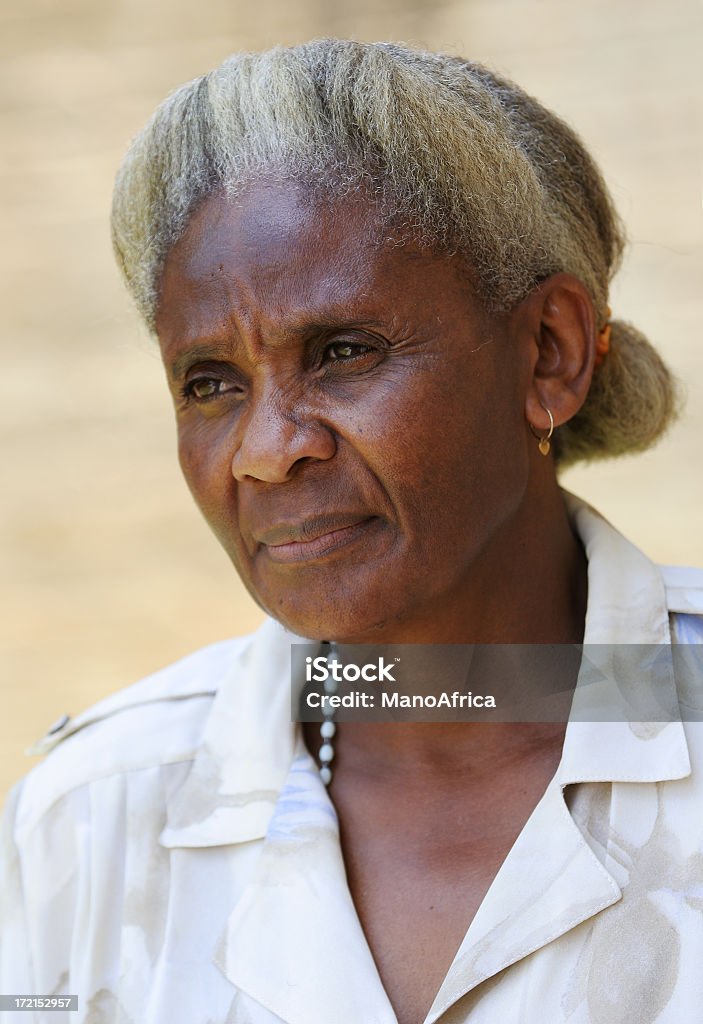 Old African Lady Frowning two An old African woman pensioner remembering days gone by; worried and alone. African-American Ethnicity Stock Photo