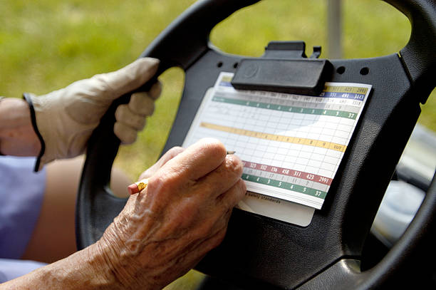 istock senior filling out a scorecard 172153107