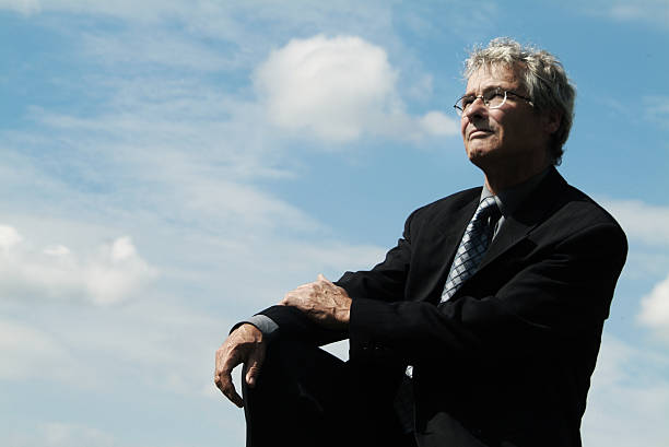 istock Businessman sitting outside looking up in the sky 172153244