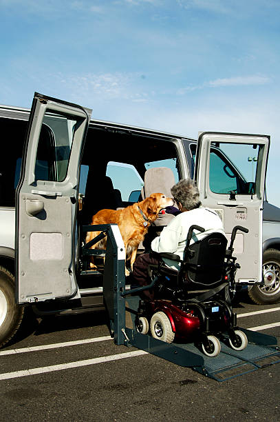 Accessibility Disabled person in power wheel chair entering a handicapped accessable van with the aid of a power lift.Please see these related images wheelchair lift stock pictures, royalty-free photos & images