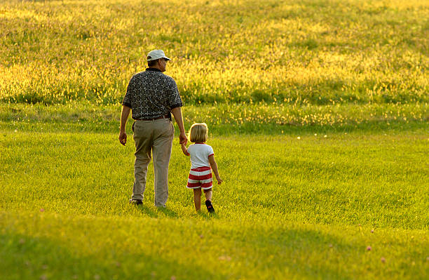 Walking with Grandpa 2 stock photo