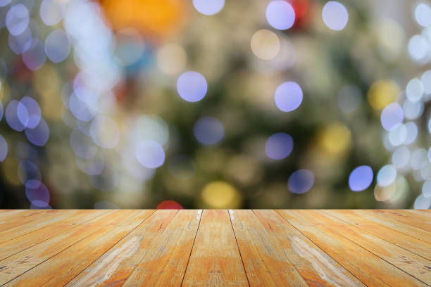 istock Empty wood table top with blur Christmas tree with bokeh light background 1721540791
