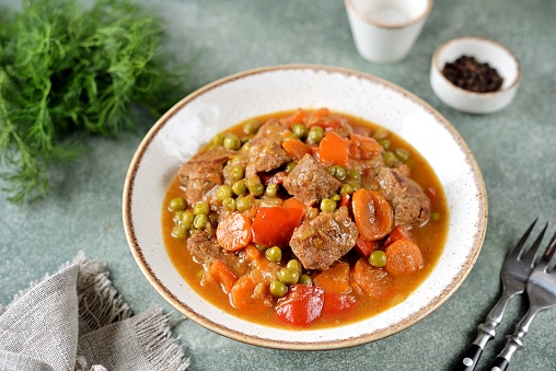 Stewed beef with carrots, bell peppers and green peas