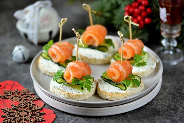 Canape with salted salmon, cucumber and soft cheese