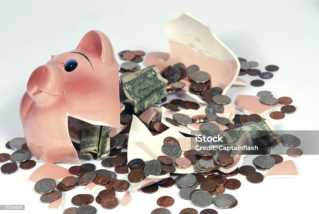 Piggy Bank Broken piggy bank with dollar bills and coins. Piggy Bank Stock Photo