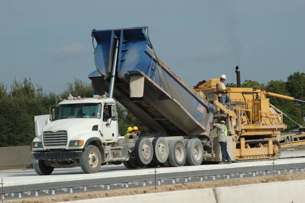 istock Dump Truck Dumping Cement Into Road Laying Construction Equipment 172154712