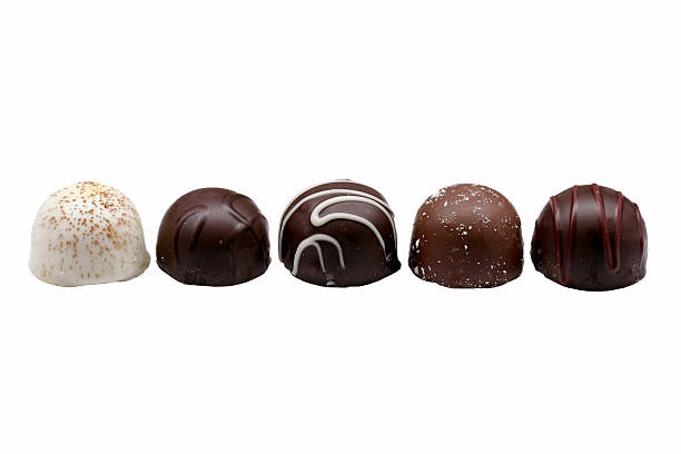 chocolate truffles "Five chocolate truffles:  coffee, dark chocolate, raspberry, almond, and cherry. Isolated on white." chocolate truffle stock pictures, royalty-free photos & images