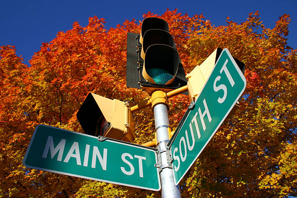 strada principale in autunno - street name sign foto e immagini stock