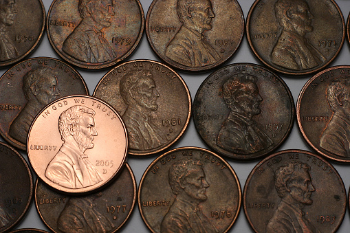 A new shiny Lincoln with older dull pennies in the background