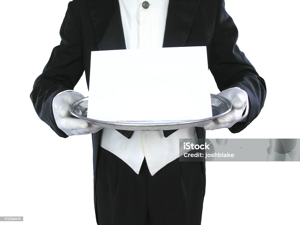 Black and white image of a butler holding a blank paper Waiter holds tray with blank card. Path included. Formal Glove Stock Photo
