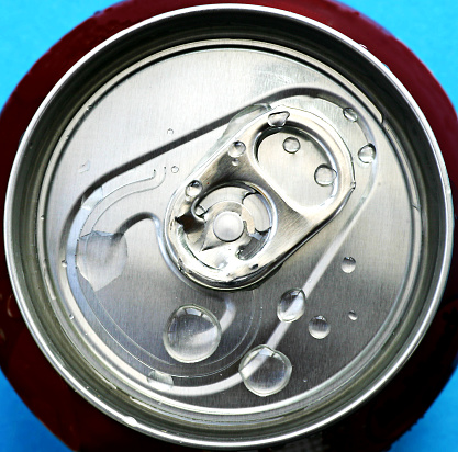 The top of a drinks can with water drops.