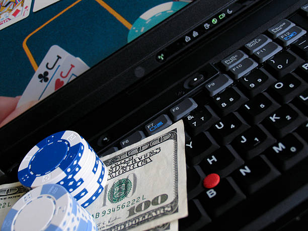 Oneline poker with cash and chips computer keyboard stock photo