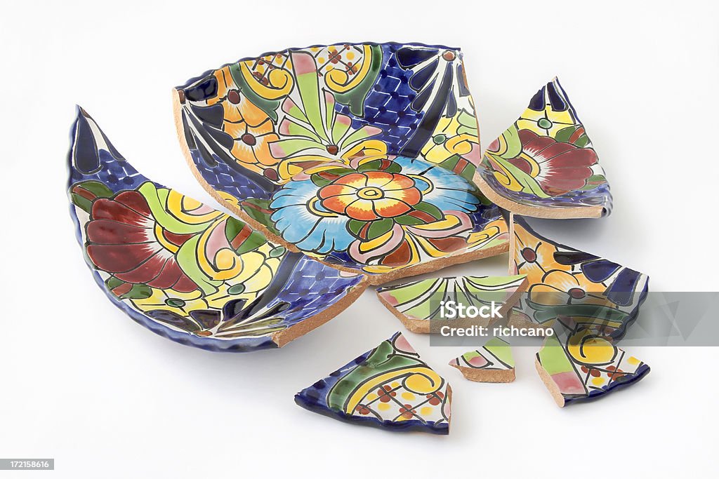A brightly painted bowl in shards on a white background Photograph of a broken bowl. Broken Stock Photo