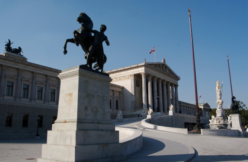 The Neo-Classic temple of parliament government in Vienna, Austria with the statue of Athena in gold helmet